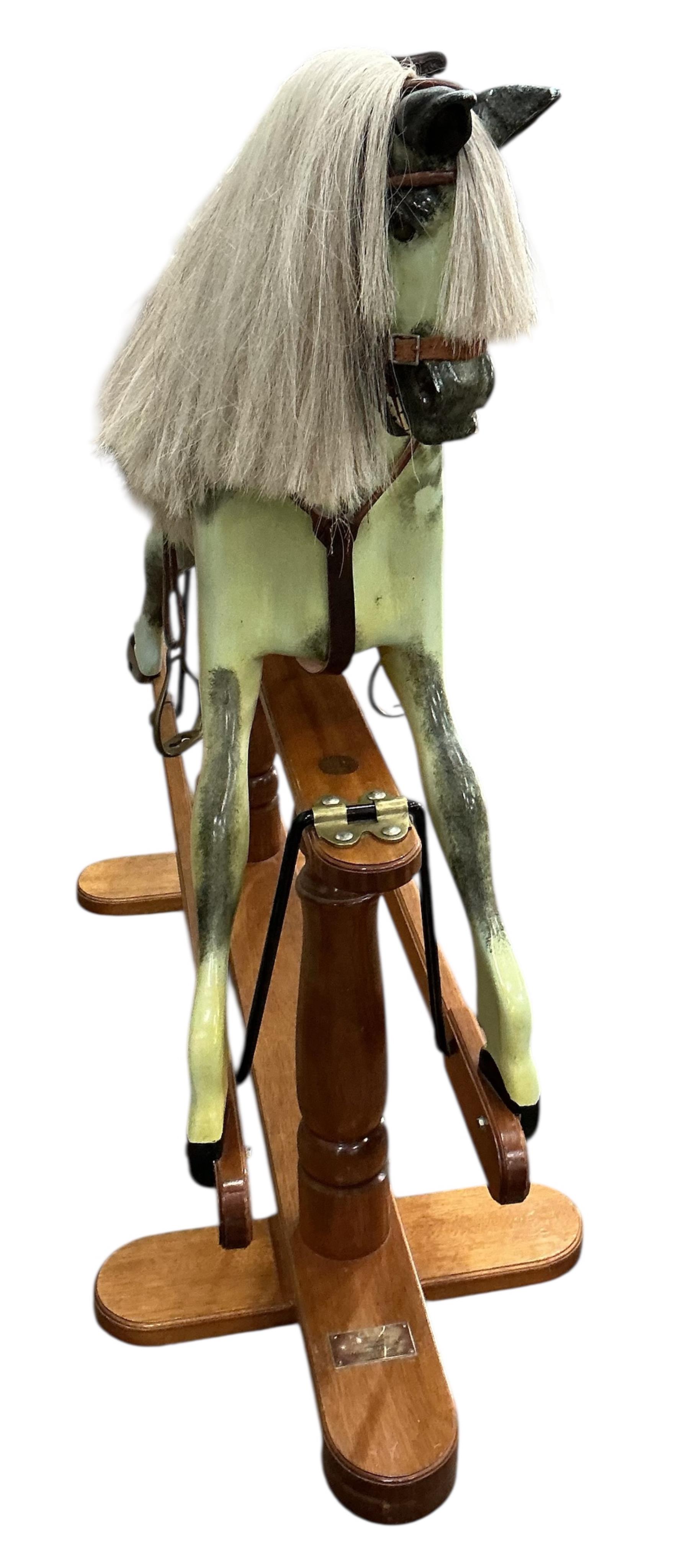 A modern Robert Mullis of Swindon dapple grey rocking horse with tan leather tack on mahogany safety frame, height 116cm